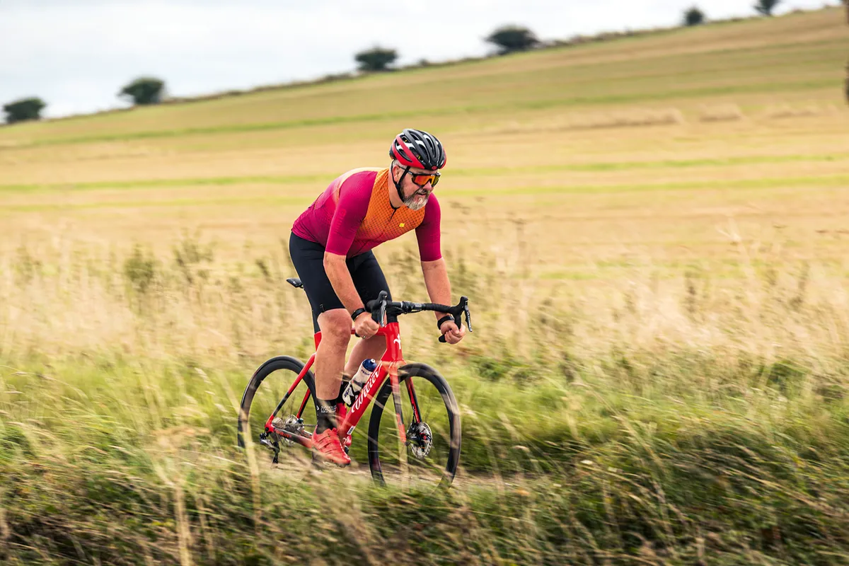Male cyclist in red top riding a red Wilier Triestina Cento10 SL Ultegra Di2 road bike