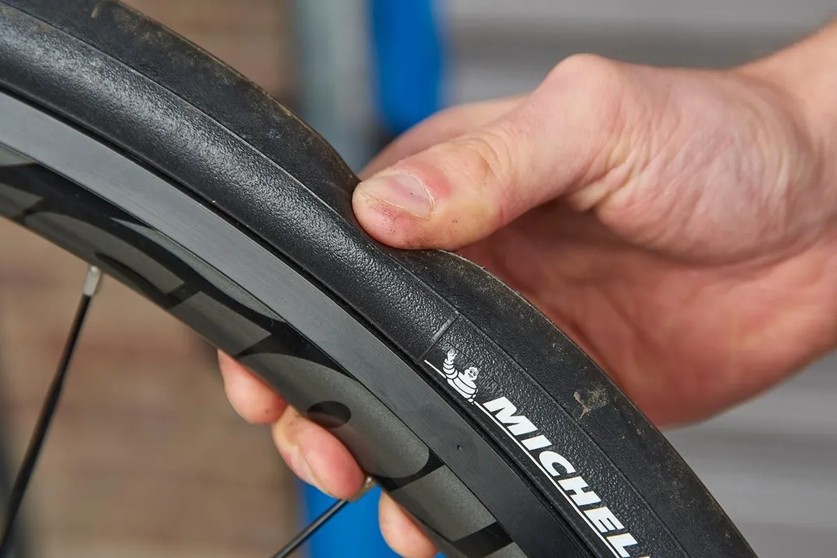 Bike mechanic checking tyres for pressure