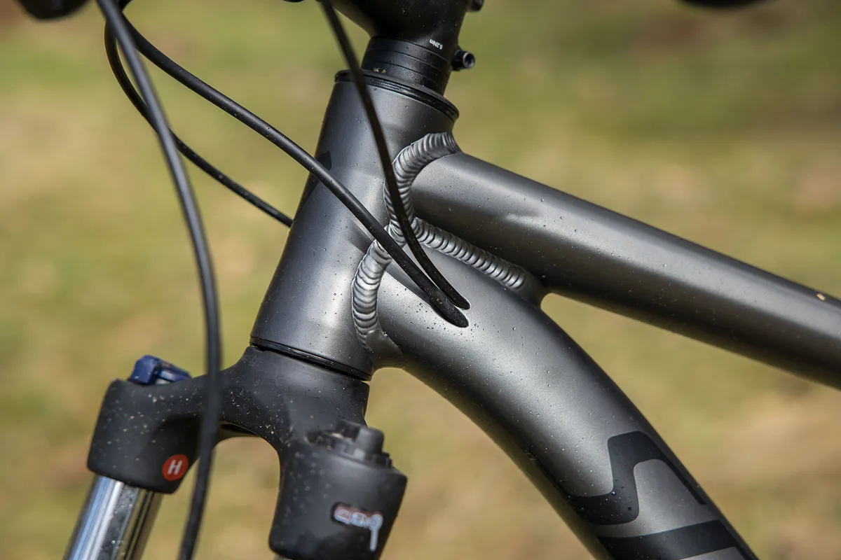 The Specialized Rockhopper Comp hardtail mountain bike has internally routed cables