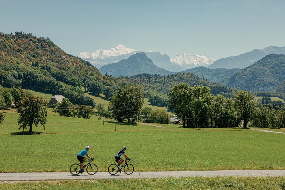 Two cyclists riding through the Swiss Alps