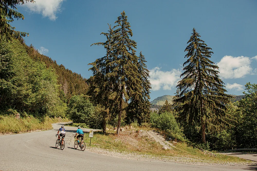 Two cyclists riding through the Swiss Alps