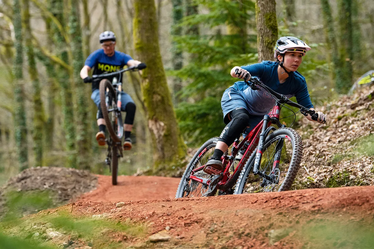 Male and female cyclists riding the Verderers Blue Trail, Forest of Dean