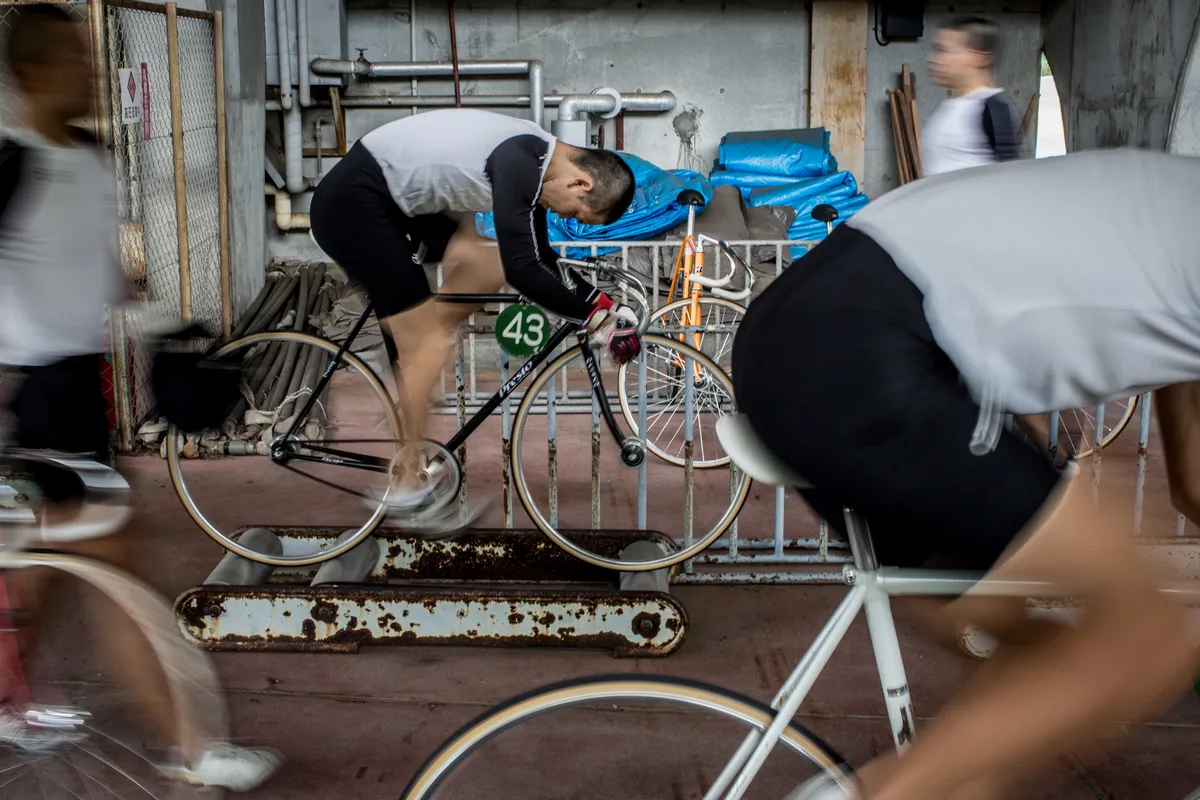IZU, JAPAN - JULY 08: Keirin students train on rollers at the Nihon Keirin Gakkou (Japan Keirin School) on July 8, 2015 in Izu, Japan. Keirin is a form of cycle racing developed in Japan around 1948 for gambling purposes and has since become extremely popular. It is one of only four sports that patrons are allowed to bet on. In 1957 the Japanese Keirin Association was founded establishing a uniform system for the sport. Today riders must complete study at the Japan Keirin School. For riders accepted to the school, they take on an extremely strict, 15hr, six day a week training schedule, before being eligible to graduate as approved professional Keirin riders able to compete in Japan's professional Keirin league. There are over 3000 registered riders in Japan and salaries for top riders can bring in as much as 2million USD, average riders can bring in salaries of 100,000USD. Despite its popularity, Keirin racing has seen a steady decline since the 1990's with attendance and revenue declining consistently. With Japan's ageing population and Keirin seen mainly as a gambling activity, it's fan base is made up primarily of punters over the age of 50. Attracting young fans is a crucial step to reinvigorating the sport. However the lack of interest from young Japanese in sports betting and the popularity of baseball and football, attracting younger spectators is an up hill battle. The JKA has taken steps to attract younger fans, In 2012 women's racing was reintroduced under the name, Girl's Keirin and promoted with a national TV advertising campaign showing riders in high heels and dresses as an attempt to attract younger viewers. With the current debate in Japan over the introduction of casinos and the popularity of Pachinko slot gambling with the younger generation, Keirin racing could see yet another decline. (Photo by Chris McGrath/Getty Images)