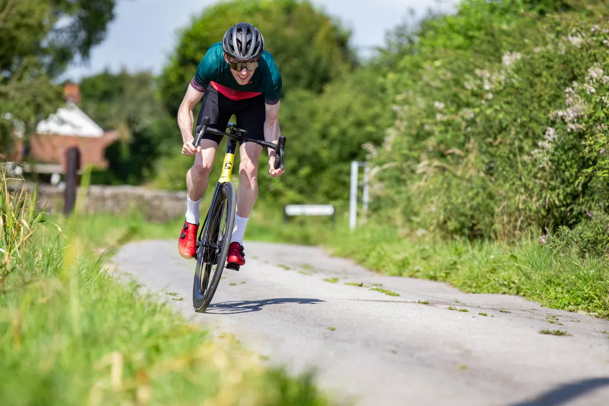 Man cycling hard in aerodynamic position