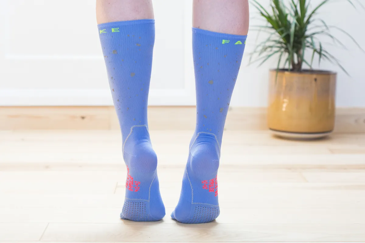 Rear view of blue cycling socks on model 