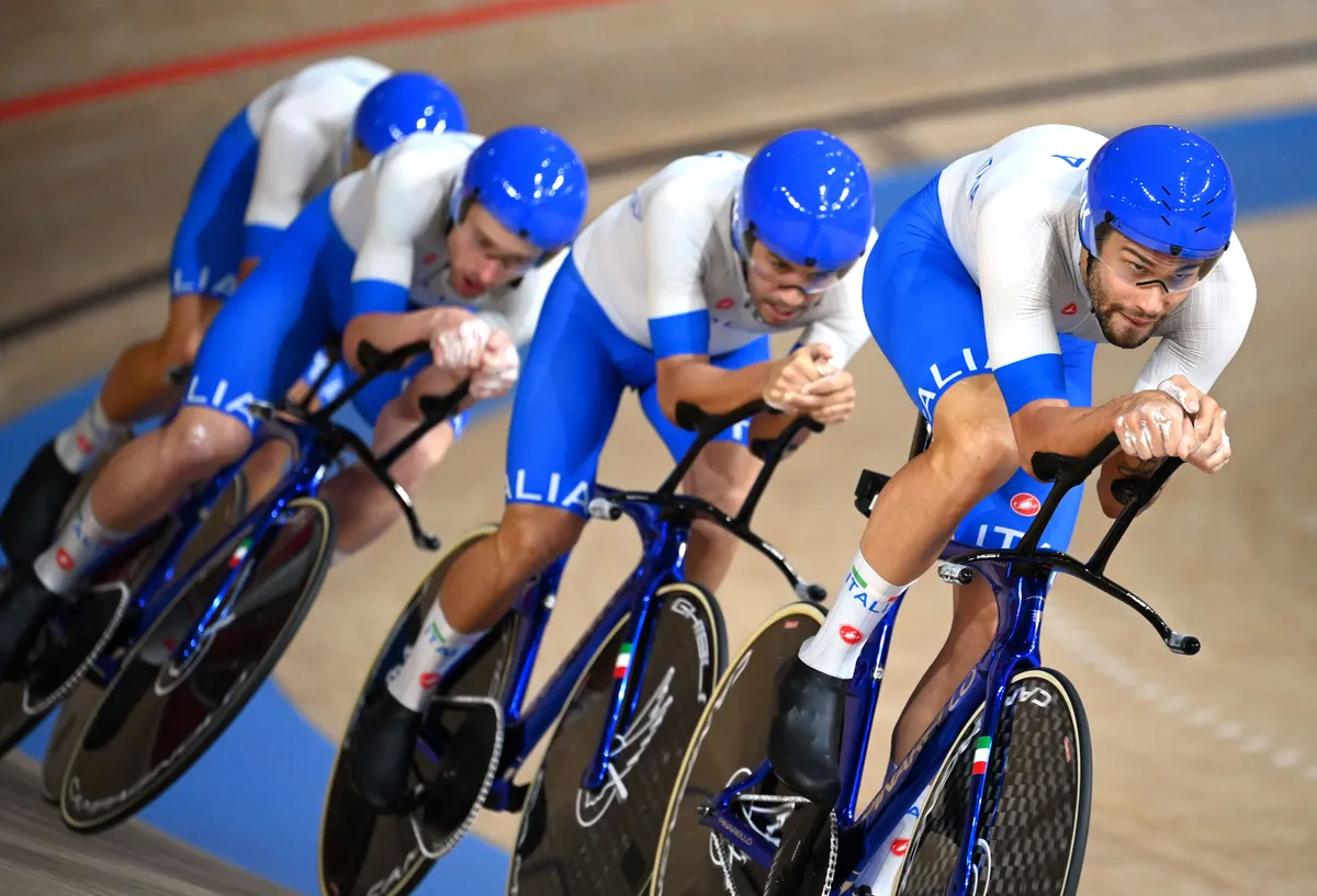 Italy's Filippo Ganna (R) and teammates compete in the men's track cycling team pursuit finals during the Tokyo 2020 Olympic Games