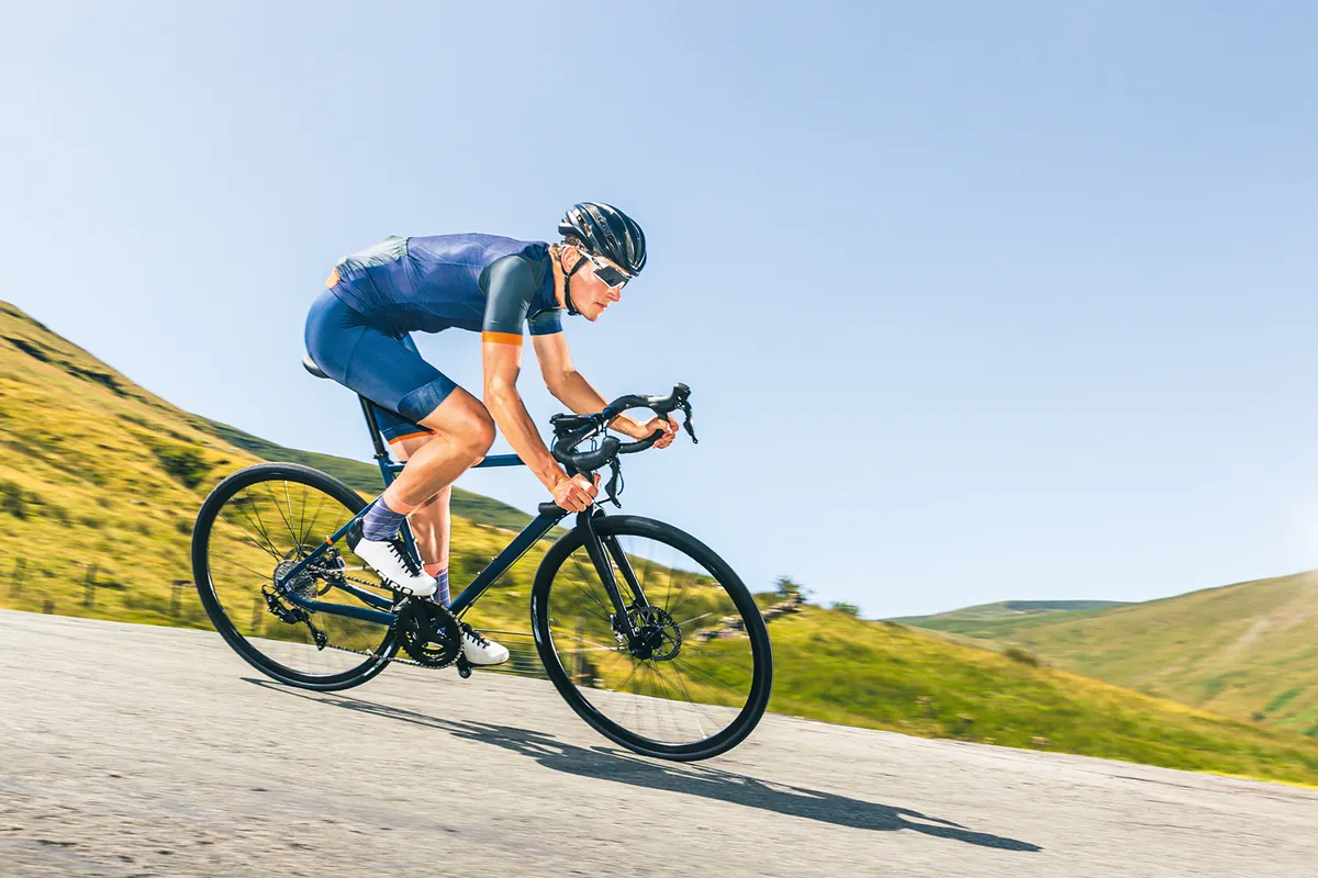 Male cyclist in blue riding the Triban RC520 Disc road bike