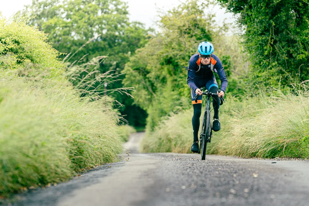 Male cyclist riding up a hill