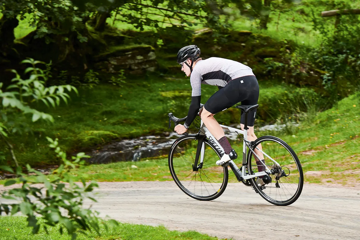 Male cyclist in grey top riding the Specialized Allez Sport road bike