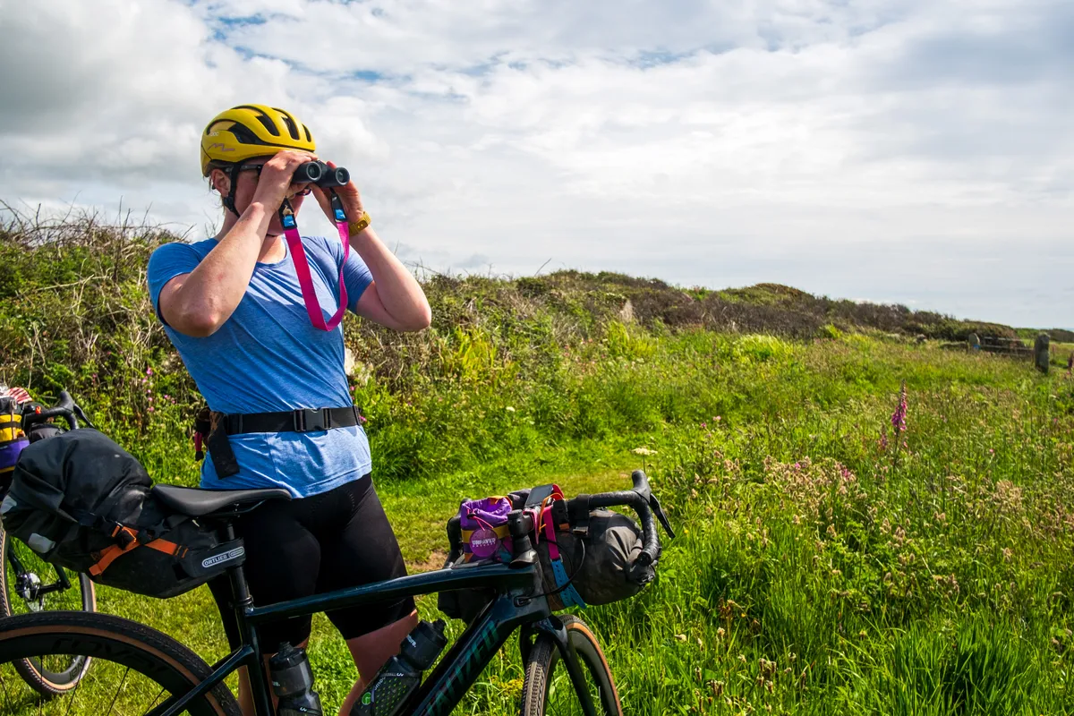Katherine Moore (Unpaved podcast) keeps a keen eye out for birds during a recce ride of Cycling UK's West Kernow Way, June 2021. The route is part of the EU-funded EXPERIENCE project to develop sustainable year-round tourism activities in Cornwall.