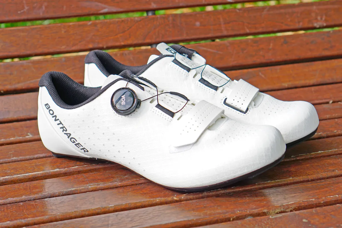 Bontrager Circuit road shoes in white photographed on a brown wooden bench