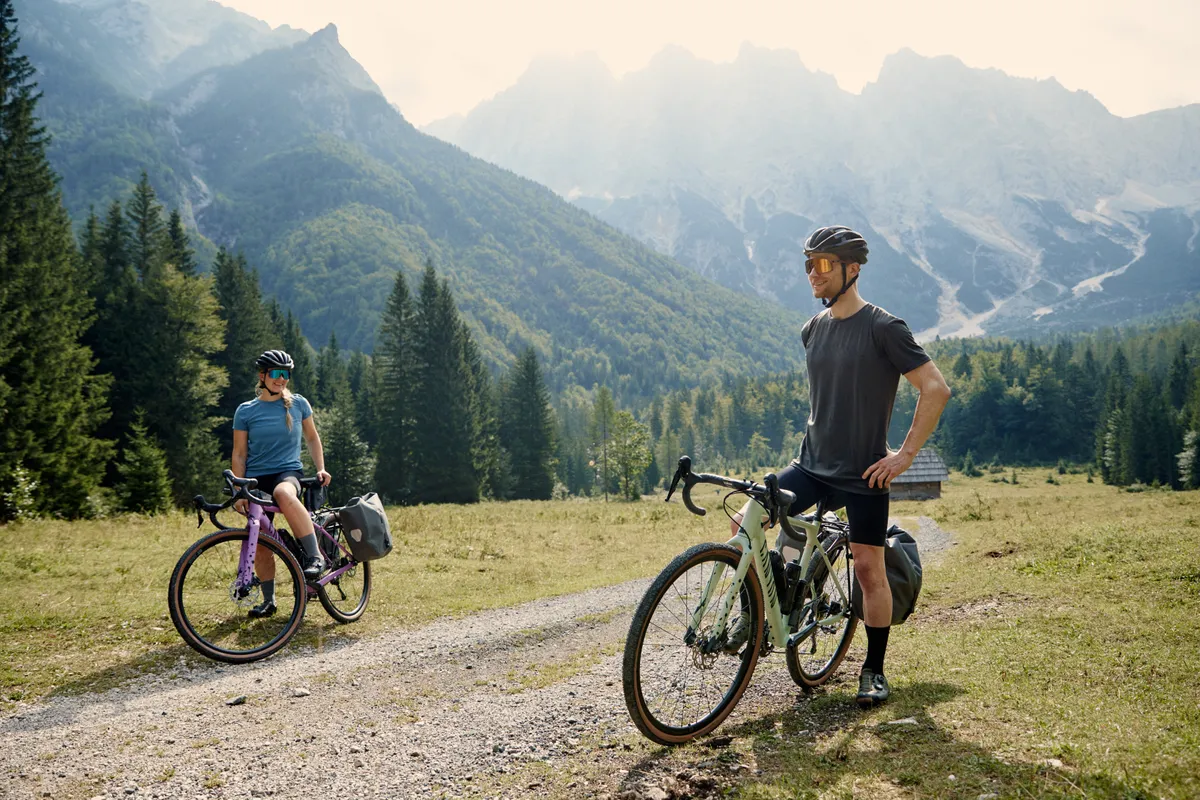 Man and woman riding Canyon Grizl AL bike in mountains