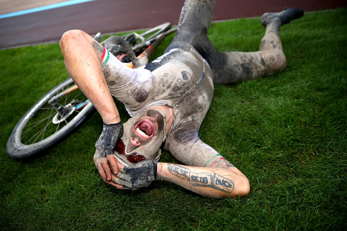 Sonny Colbrelli of Italy and Team Bahrain Victorious covered in mud celebrates winning in the Roubaix Velodrome