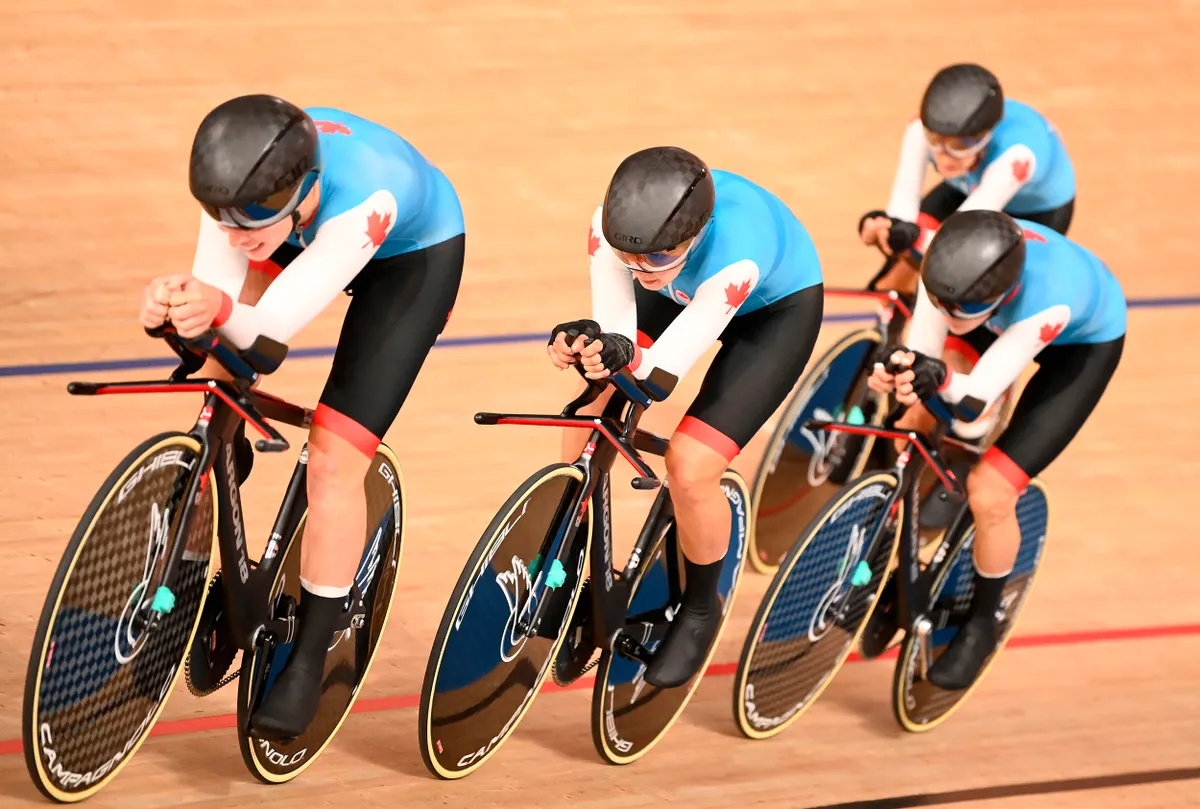 Four women ride around velodrome wearing Canadian national colours