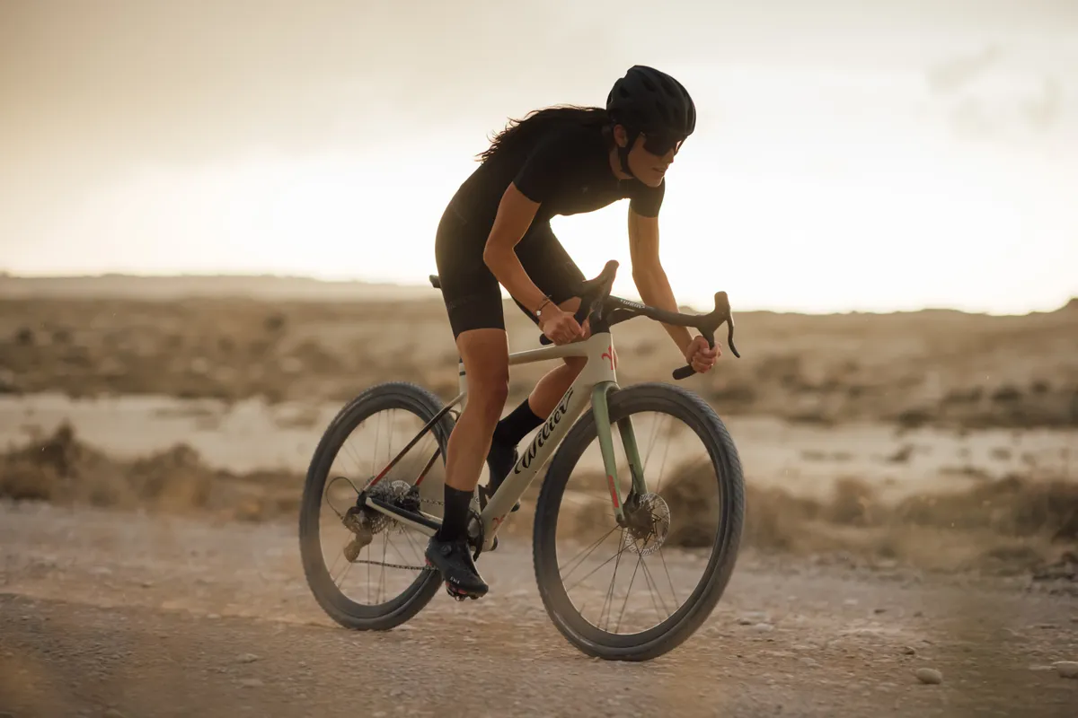 Wilier Rave SLR being ridden by a woman along a gravel road