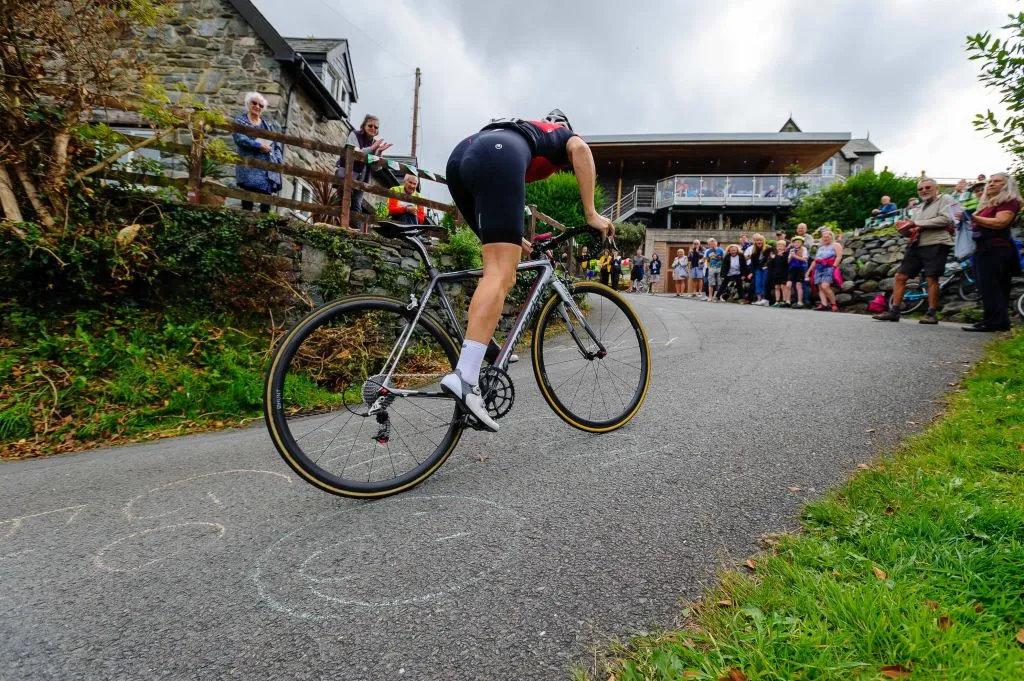 HARLECH, WALES - AUGUST 11: Cyclists take part in the Harlech Hell Climb on August 11, 2019 in Harlech, Wales. Today the inaugural Harlech hill climb event takes place on the street named Ffordd Pen Llech. The climb, which has been named by Guinness World Records as the steepest street in the world, stretches across 310 metres with a gradient of 37.45%. (Photo by Mark Bullimore/Getty Images)