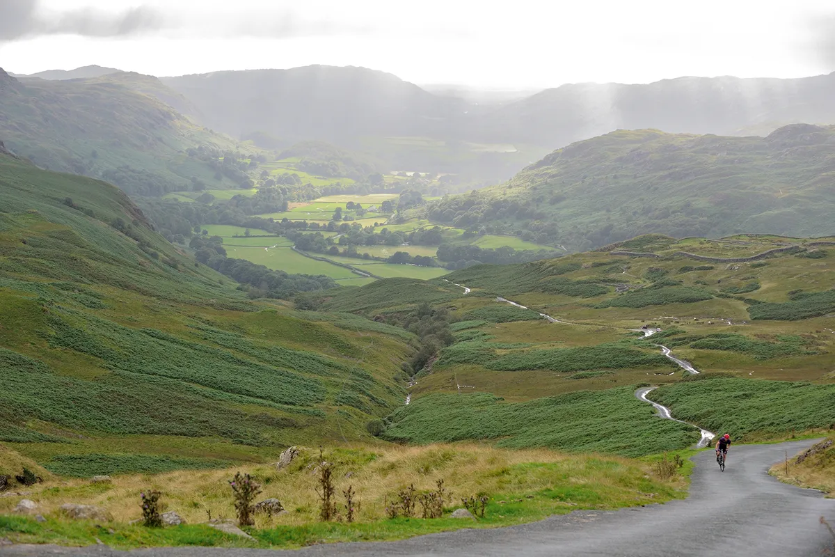 Cyclist riding on the Hardknott Pass, Lake District