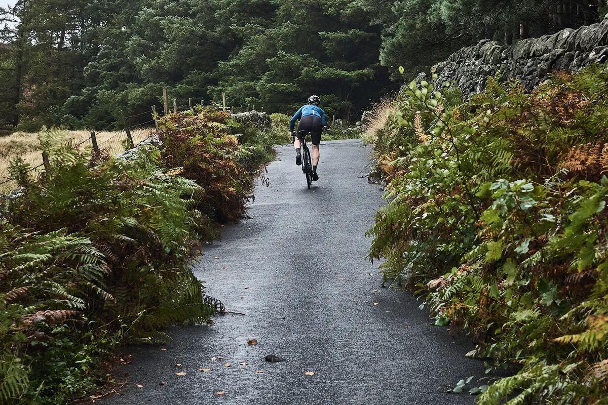 Cyclist riding the Bamford Clough, Peak District