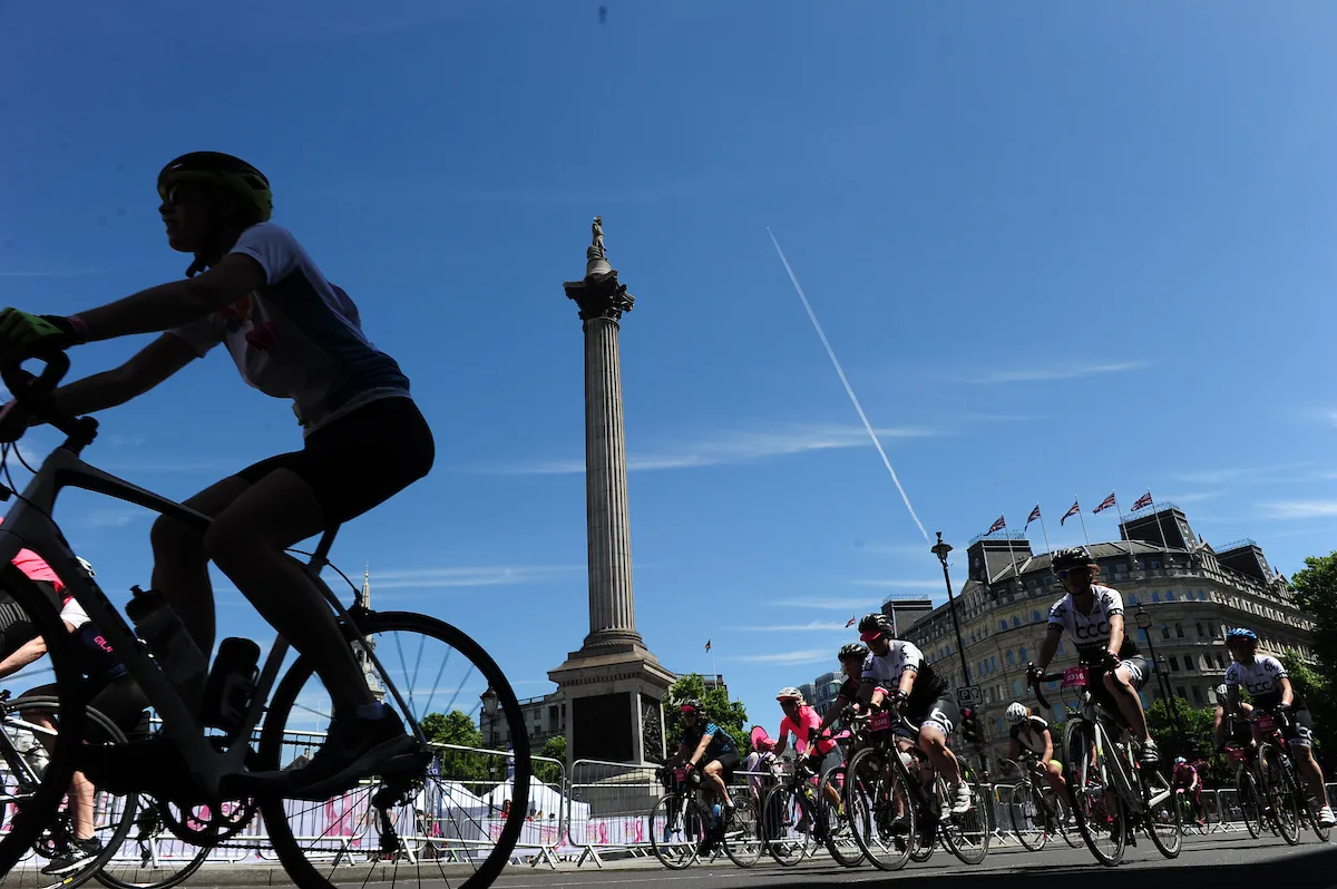 Female cyclists riding past Nelson's Column in London