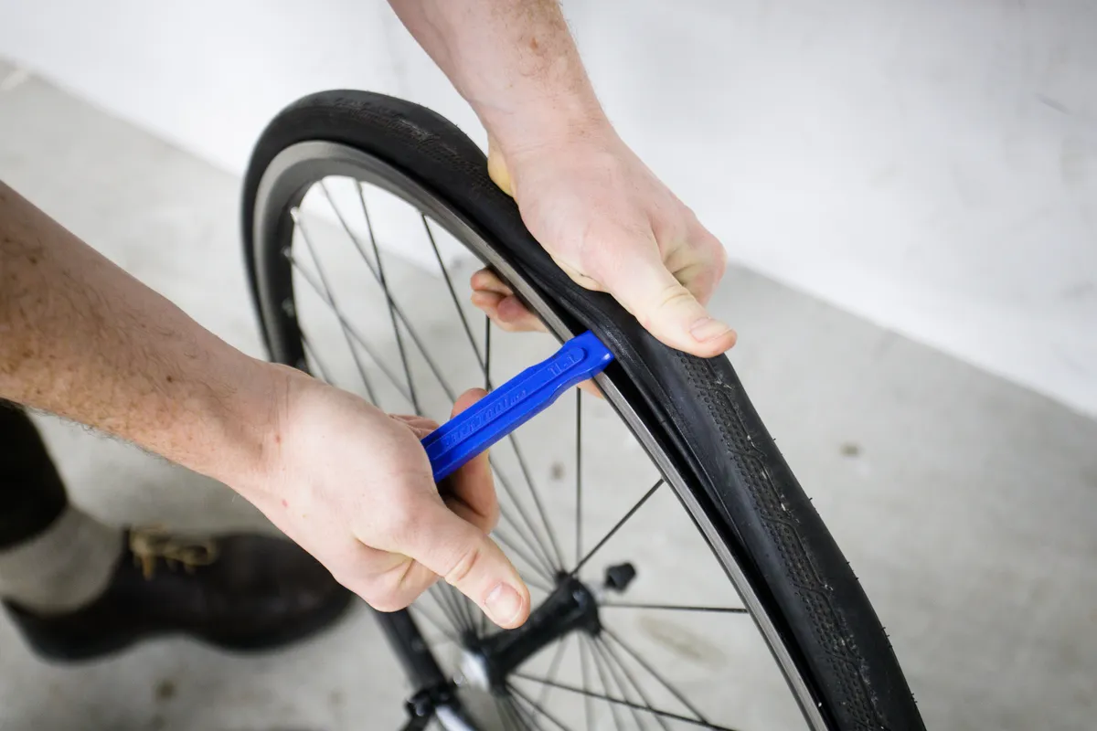Using a tyre lever to remove a bike tyre