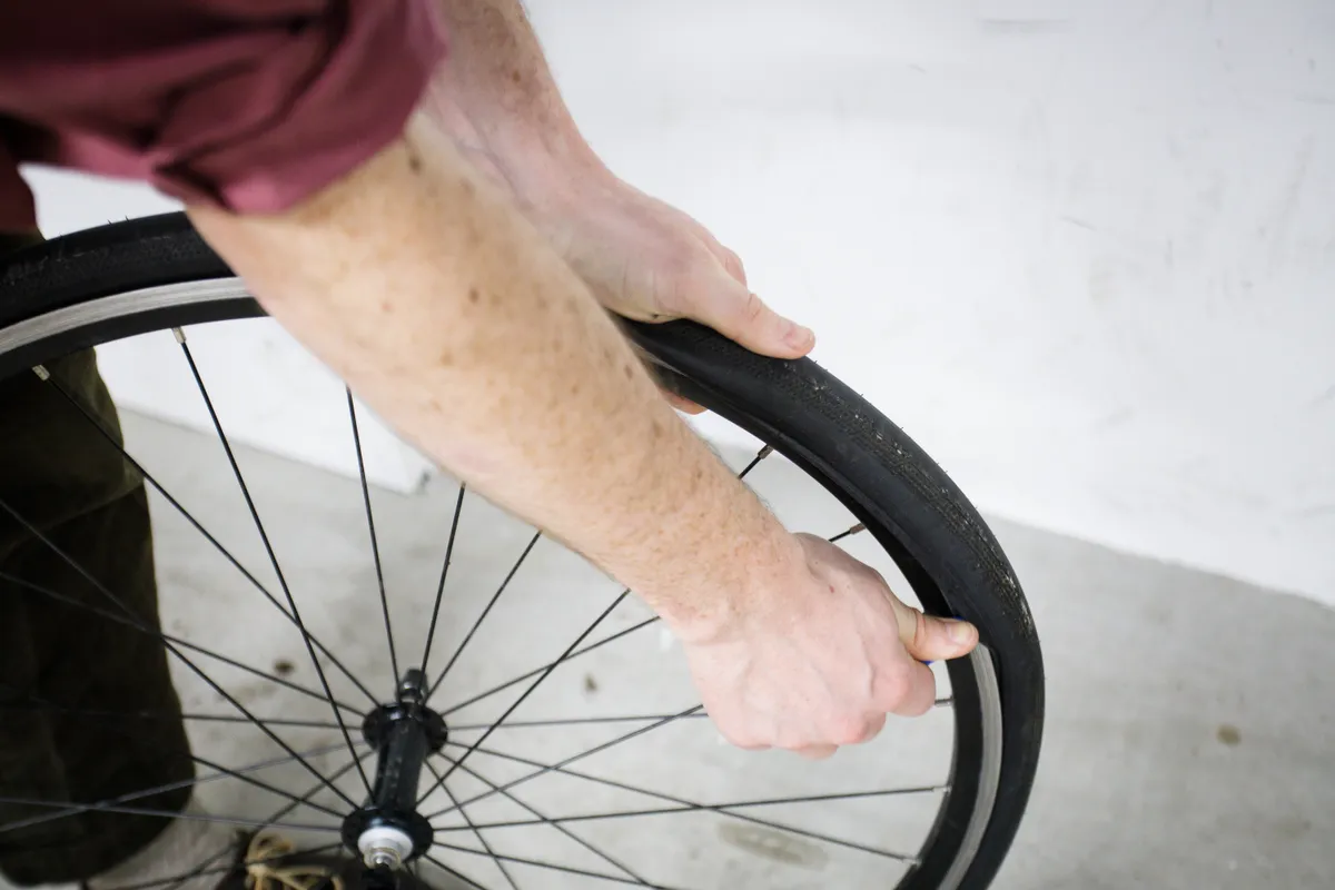 Using a tyre lever to remove a bike tyre