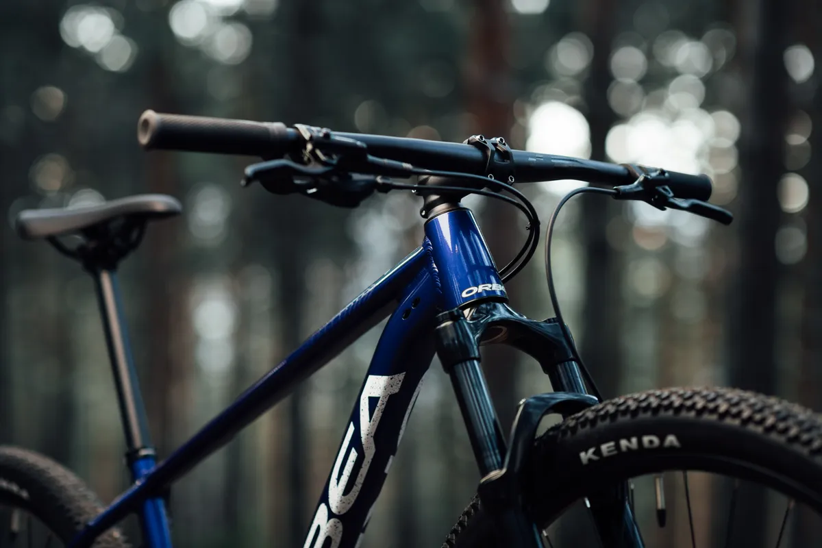 Orbea Onna's front end against a forest background