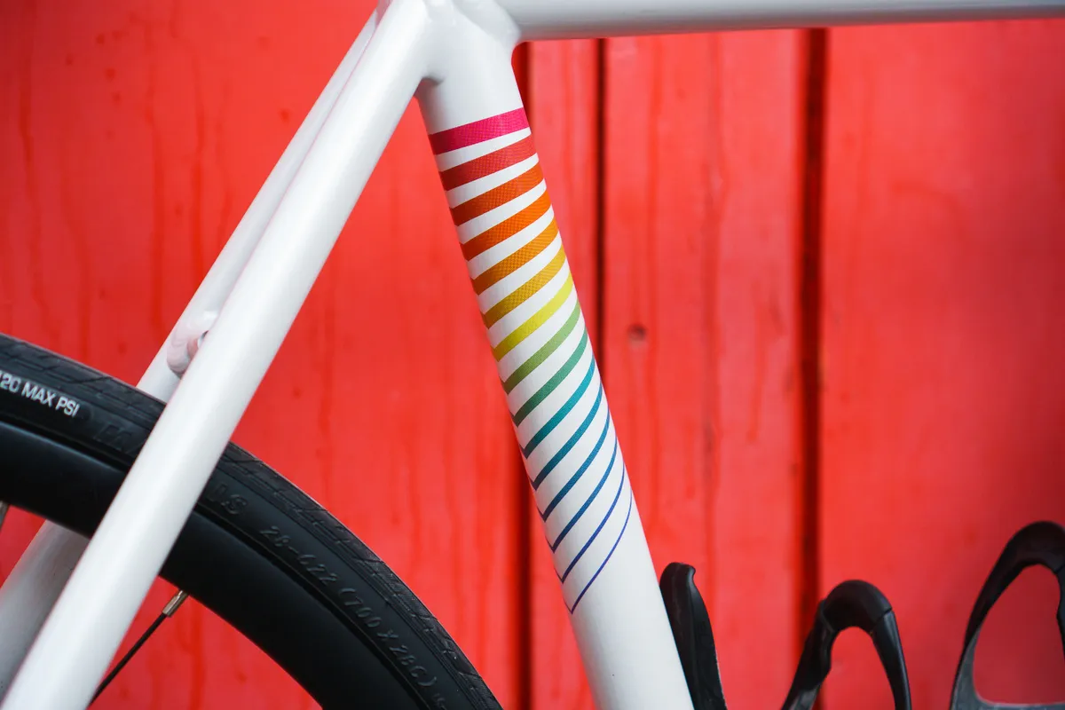 Tie-dye colour on seat tube of State Undefeated against a red background.