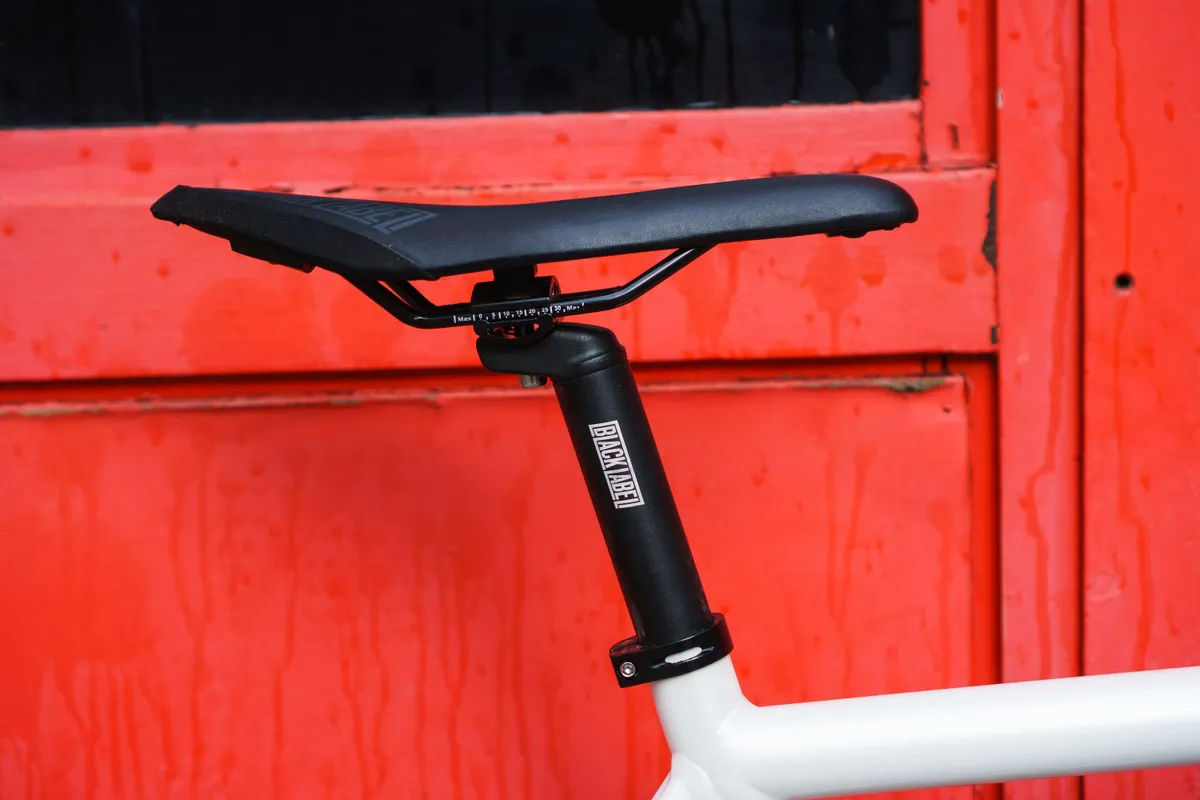 Black Label seatpost against a red background