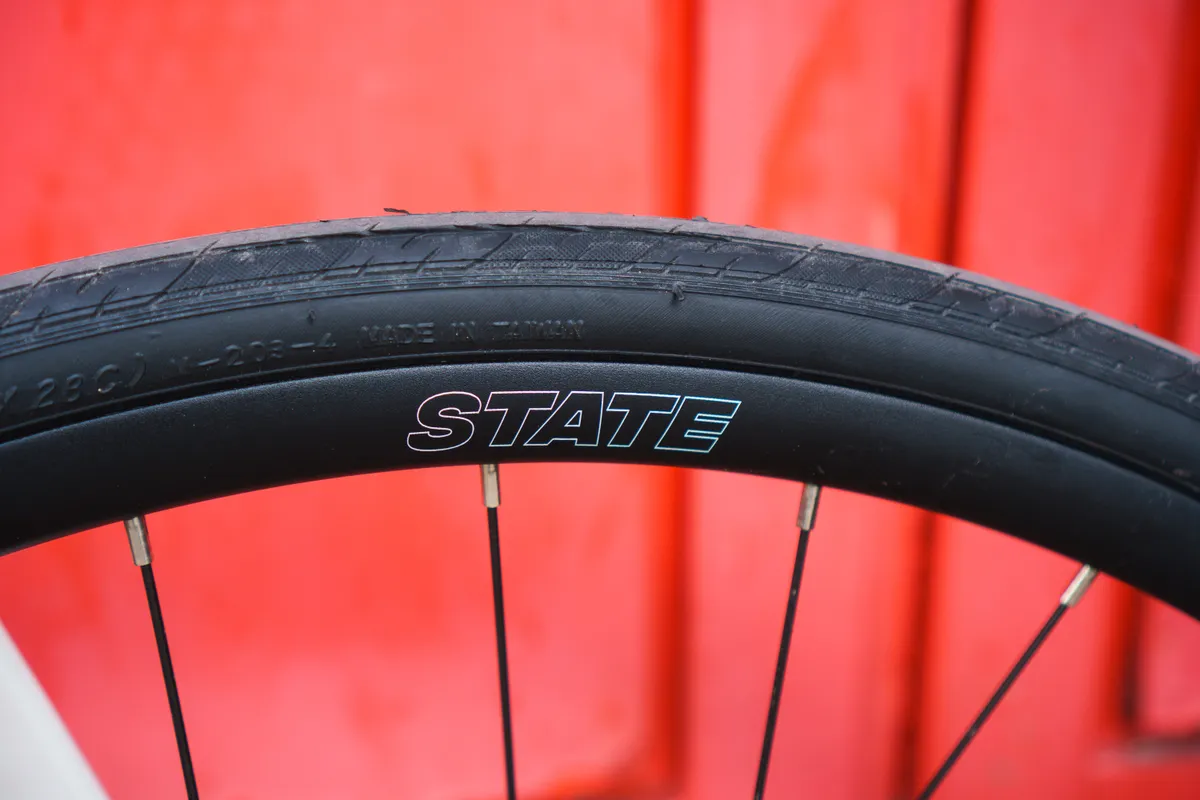 State branded rim against a red background