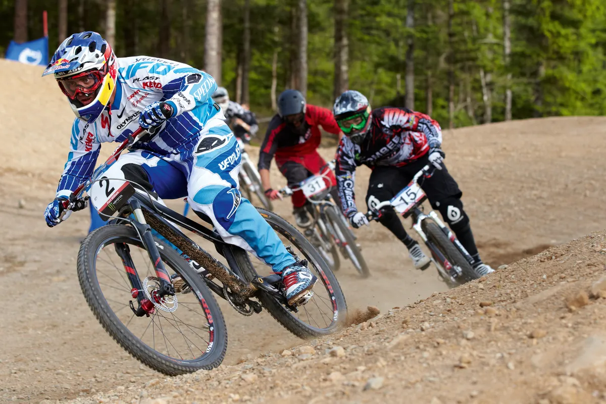 Riders racing in a four-cross race