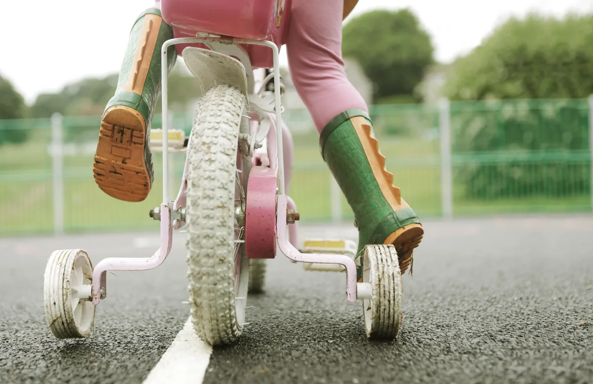 Toddler on bicycle with stabilisers