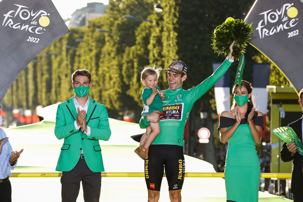 PARIS, FRANCE - JULY 24: Jumbo-Visma team's Belgian rider Wout Van Aert (C), holding his son Georges, celebrates on the podium with the sprinter's green jersey after the 21st and final stage of the 109th edition of the Tour de France cycling race, 115,6 km between La Defense Arena in Nanterre, outside Paris, and the Champs-Elysees / #TDF2022 / #WorldTour / on July 24, 2022 in Paris, France. (Photo by Antonio Borga/Eurasia Sport Images/Getty Images)