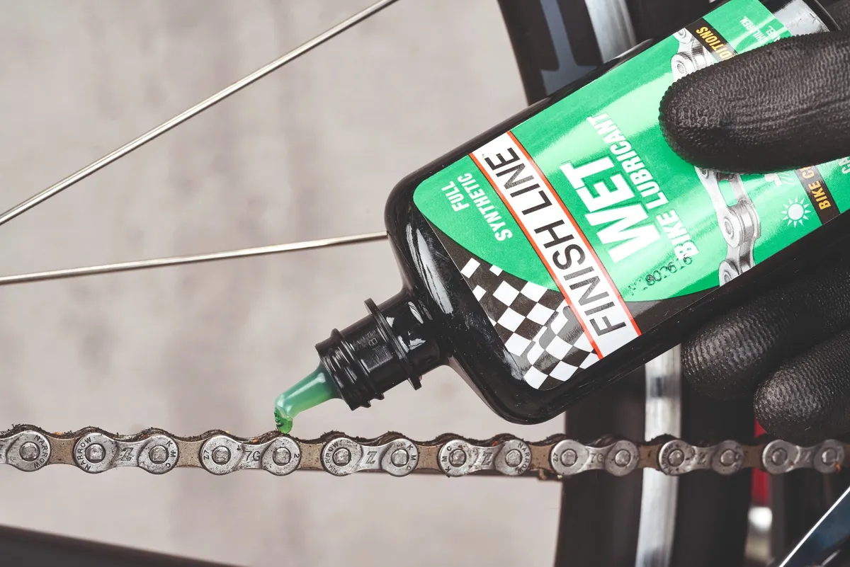 Applying chain lube to a bike chain