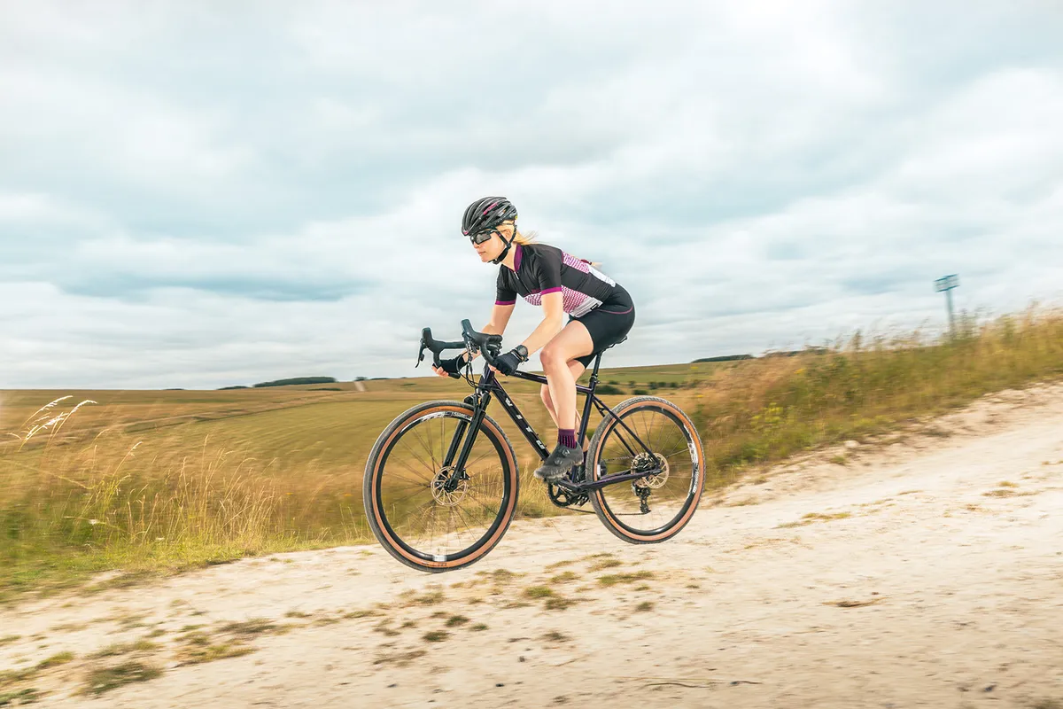 Female cyclist riding the Vitus Substance VRS-1 HT Apex gravel bike