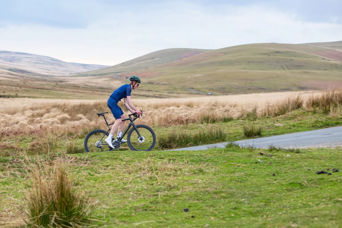 Jack Evans, digital writer at BikeRadar, climbing a hill in Wales.
