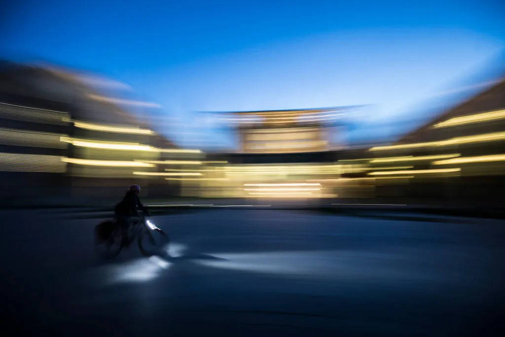BERLIN, GERMANY - APRIL 25: A cyclist in front of the Federal Chancellery in the Blue Hour pictured on April 25, 2019 in Berlin, Germany. (Photo by Florian Gaertner/Photothek via Getty Images)