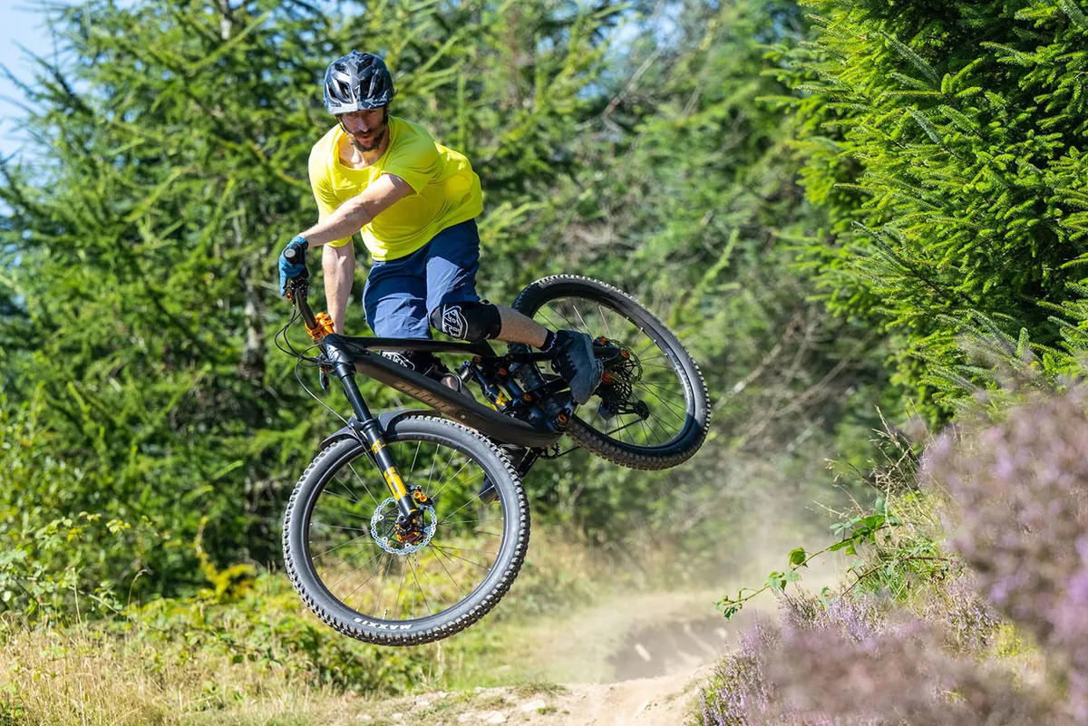 Male cyclist in yellow top riding the Hope HB.916 full suspension mountain bike