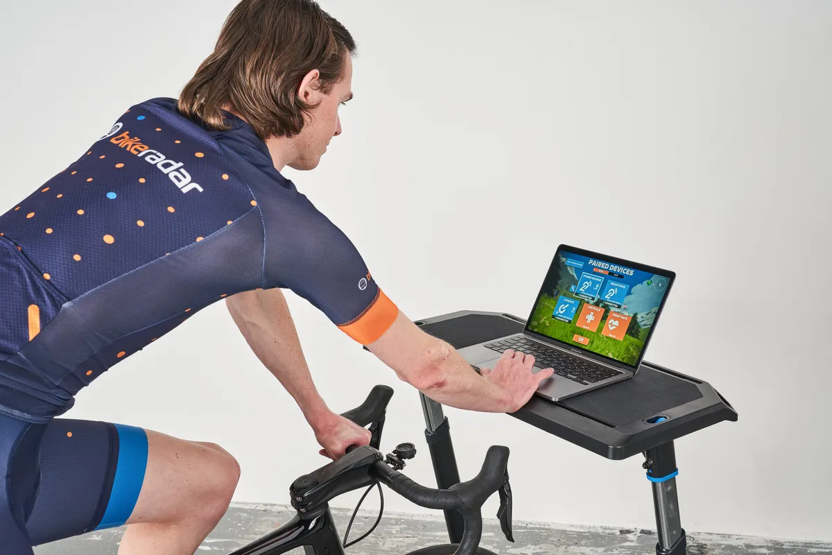 Simon von Bromley using Zwift on a laptop on a Wahoo Desk