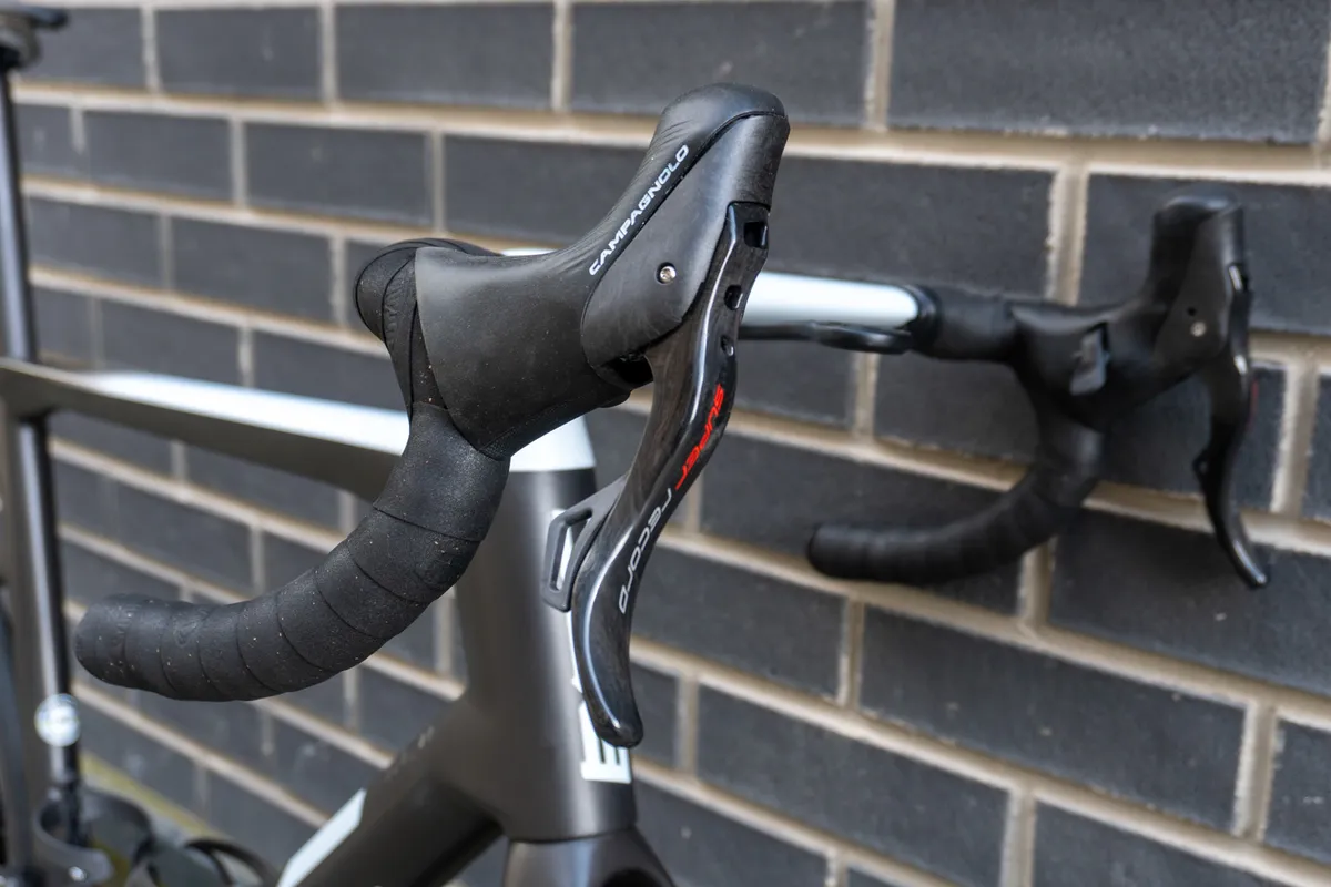 Campagnolo Super Record EPS 12 speed shifter on BMC Teammachine SLR01 against a wall