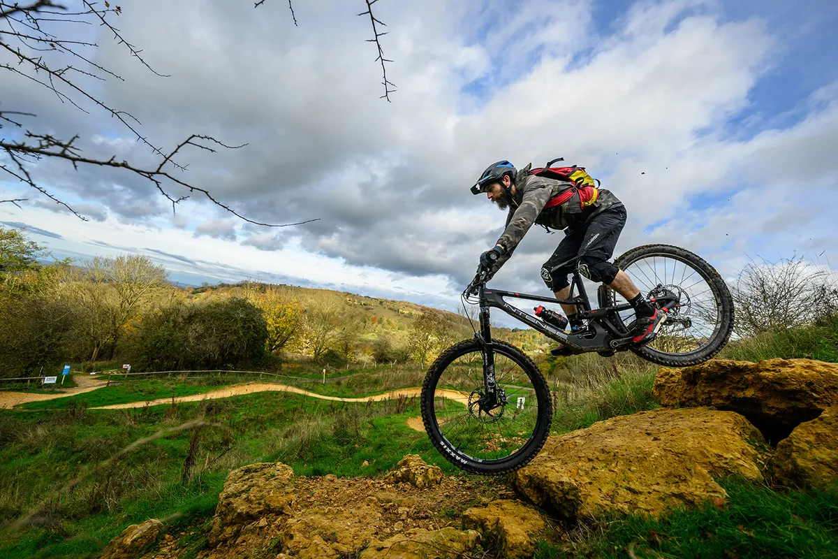 Male cyclist riding the Intense Tracer 29 full suspension mountain bike