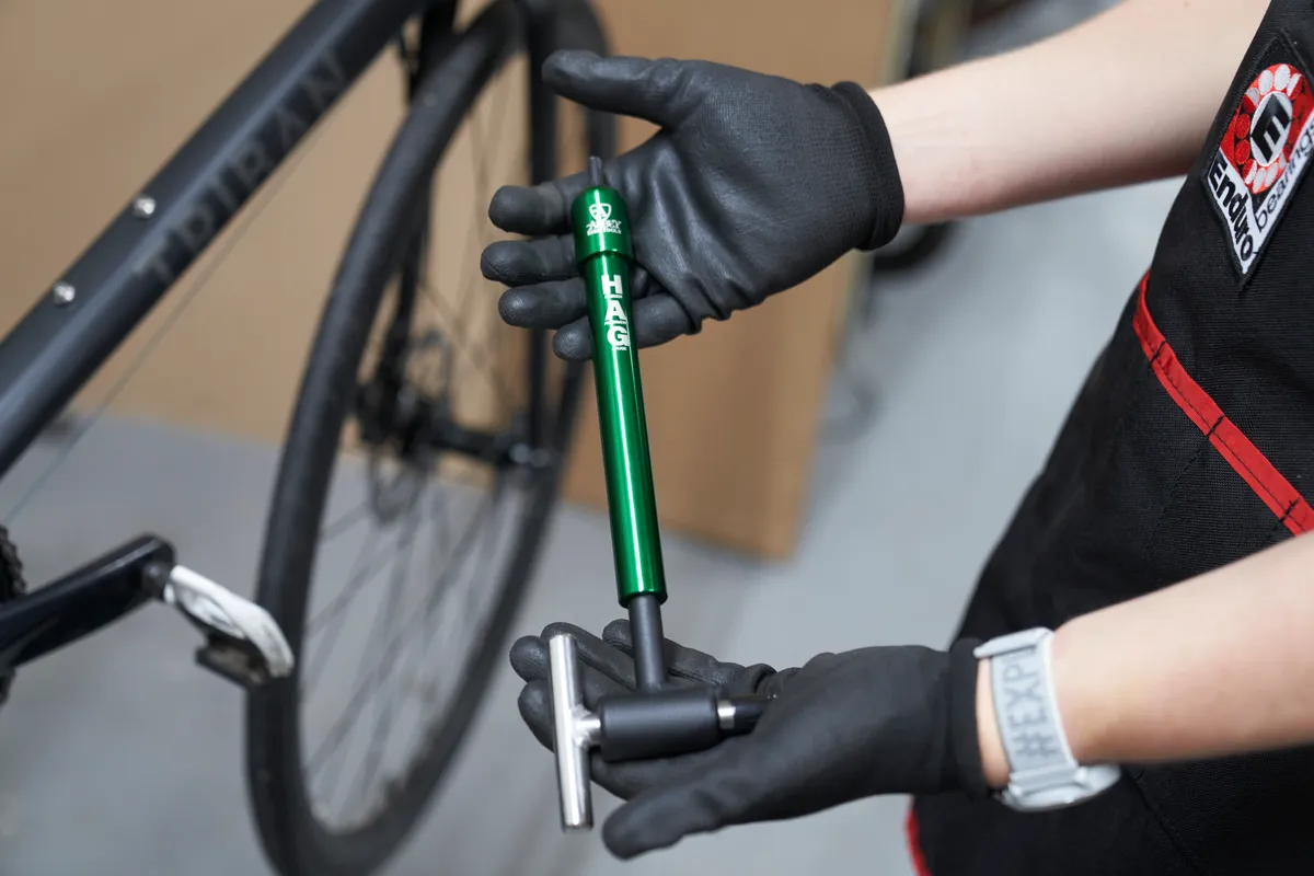 Oscar Huckle holding Abbey Bike Tools Derailleur Alignment Gauge