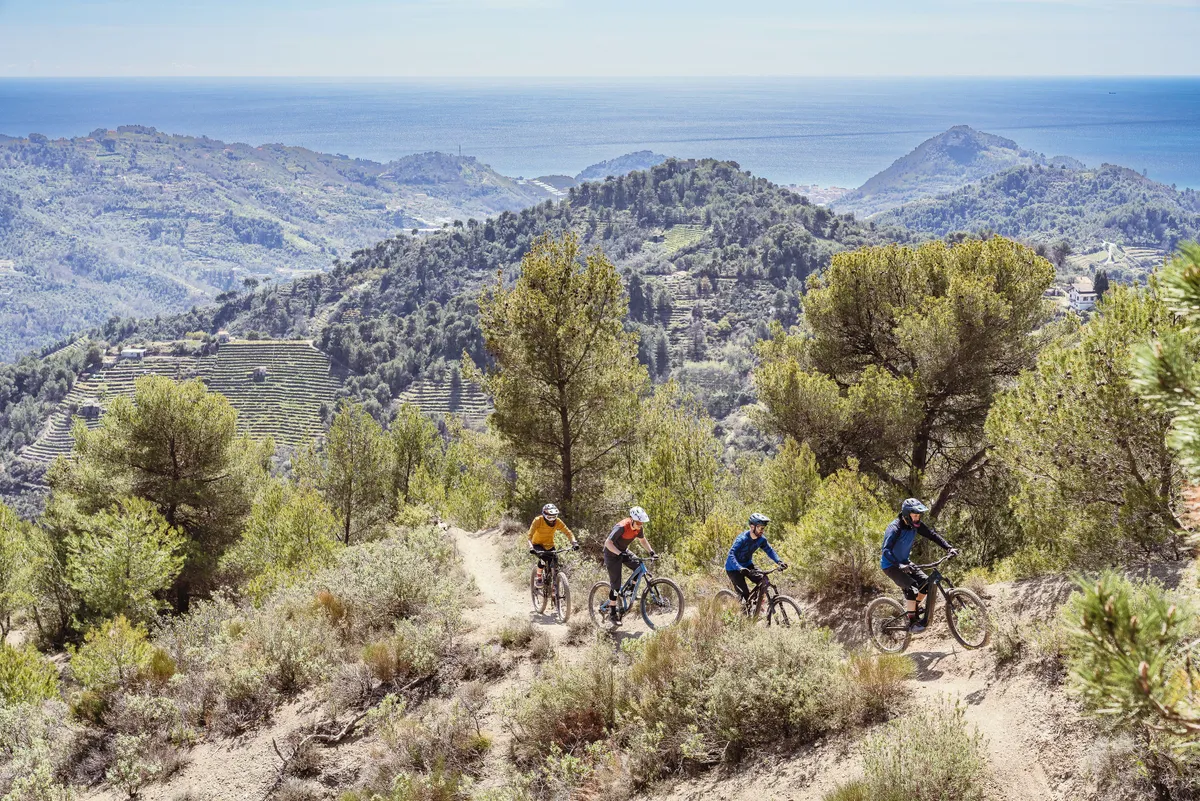 Four riders climbing uphill on mountain bikes in Dolceacqua for Bike of the Year 2023