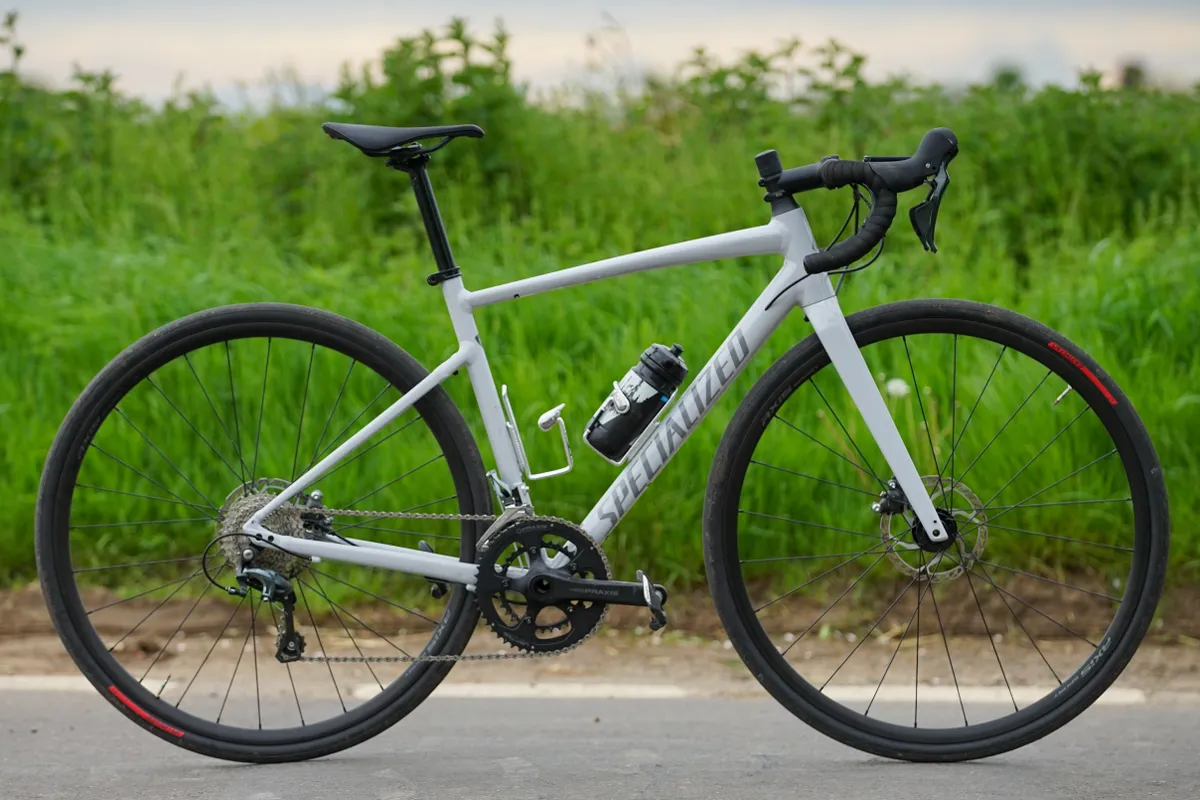 Specialized Allez Sport in Dove Grey sits on a country lane in front of a bright green verge.