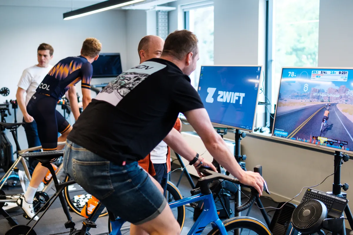 Journalists testing the Zwift Play controller at Zwift HQ