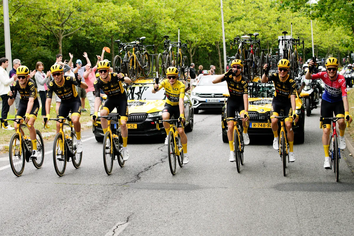 Jonas Vingegaard celebrates with team-mates at the end of the 2023 Tour de France