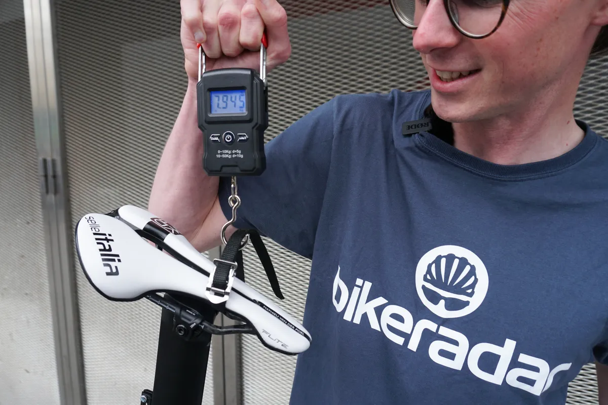 Simon von Bromley weighing Mathieu van der Poel’s Canyon Aeroad CFR before the 2023 Tour de France