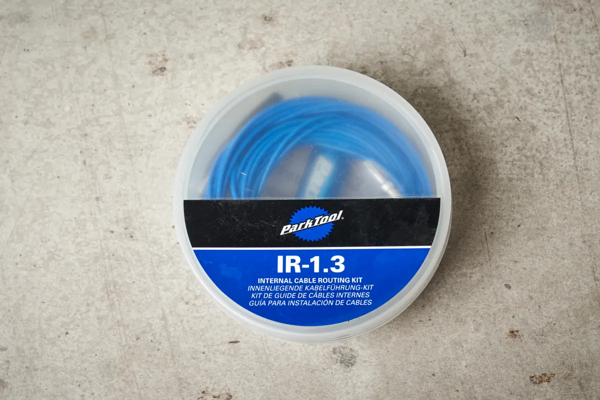 Park Tool IR-1.3 Internal Cable Routing Kit against a stone surface