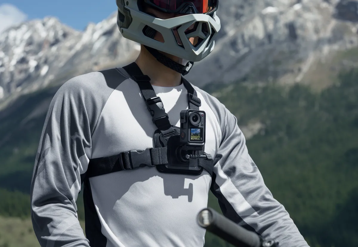 DJI Osmo Action 4 action camera mounted to chest mount of male mountain biker