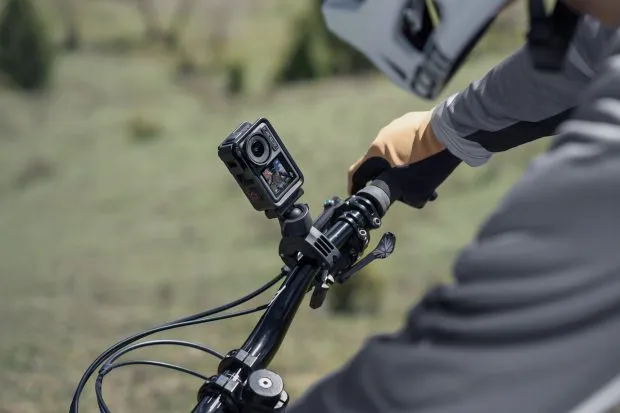 DJI Osmo Action 4 Action Camera mounted on mountain bike handlebar in portrait orientation for social media content creation