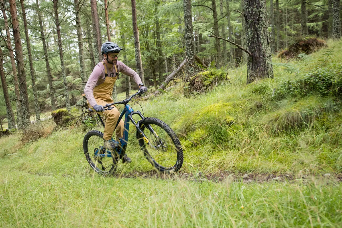 Deviate Highlander II high pivot trail mountain bike ridden by male mountain bike tester Alex Evans on a trail called Green Wing in Scotland's Tweed Valley in the UK.